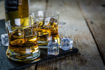 Whiskey with ice in glasses