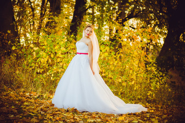 Fototapeta premium Beautiful bride walking near old castle before wedding ceremony