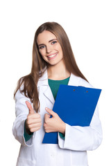 Young female student doctor with a tablet on a white background showing thumb