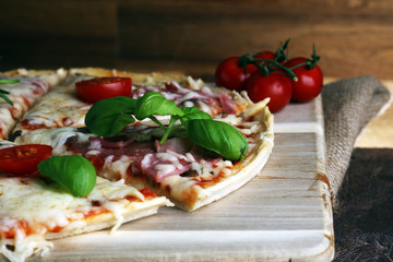 Hot true PEPPERONI ITALIAN PIZZA with salami and cheese. TOP VIEW Tasty traditional pepperoni pizza on board on wooden table with decoration