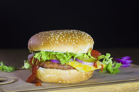 fresh tasty burger on a black background