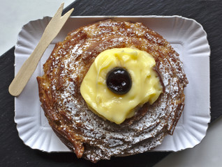 zeppola, or zeppola of st Joseph, typical sweet of southern Italy, on slate, su piano di ardesia