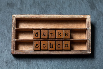 Danke schon Thank you in German translation. Vintage box, wooden cubes thankful phrase message...