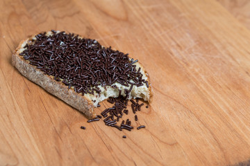 Bite Taken Out of Bread with Chocolate Sprinkles