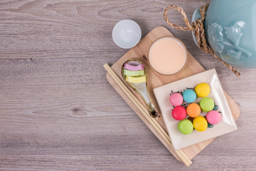 Sweet colorful macaroons on a wood background