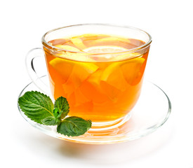 Isolated transparent cup of herbal tea with lemon and mint