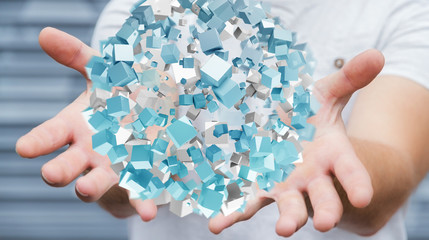 Businessman holding flying abstract sphere with shiny cube 3D rendering