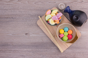 Sweet colorful macaroons on a wood background