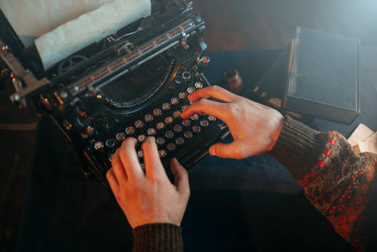 Male hands typing on retro typewriter