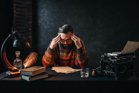 Bearded author in glasses reading his work