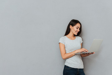 Smiling woman using laptop