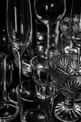 Clean different glasses on dark background. vertical