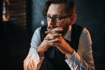 Serious brooding bearded man in glasses