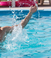 Splashing water with a hand in the pool