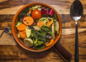 Italian vegetable minestrone soup with potatoes, carrots, onion, potatoes and bread