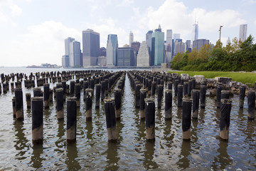 Manhattan skyline from weathered dock piling in Brooklyn