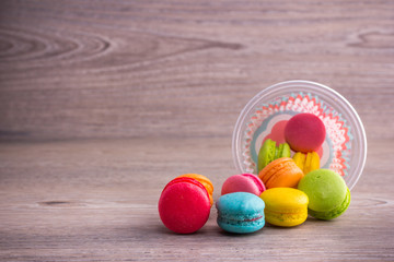 Sweet colorful macaroons on a wood background