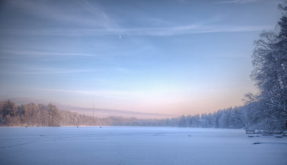 Fototapeta na wymiar Fishers at frozen lake