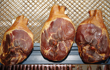 Hungarian mangalica pork ham hanging on the farmers market