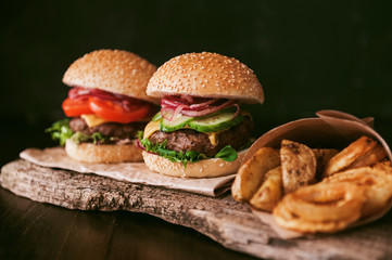 two mouth-watering, delicious homemade burger used to chop beef. on the wooden table.
