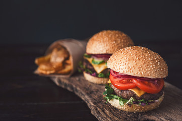two mouth-watering, delicious homemade burger used to chop beef. on the wooden table.