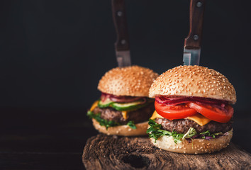 Two mouth-watering, delicious homemade burger used to chop beef. on the wooden table. The burgers...