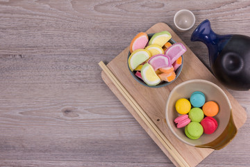 Sweet colorful macaroons on a wood background