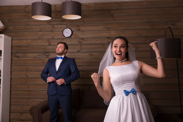 Portrait of happy bride and serious groom