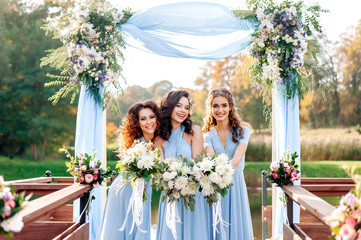 Beautiful bridesmaids at the wedding. Lovely dresses. walk in the park