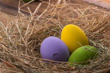Naklejka na ściany i meble Easter eggs in nest on old wooden background