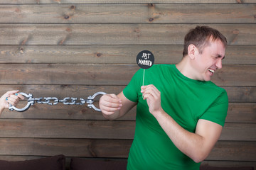 Man handcuffed to marriage shows icon on a stick