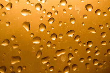 Water drops on the glass at sunset