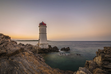 Fototapeta na wymiar Lighthouse at sunset in Sardinia-Italy