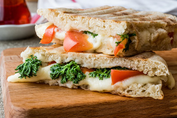 Turkish Bazlama Tost / Toast sandwich with melted cheese, tomatoes, dill and tea.