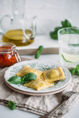 The man is cooking Ravioli with spinach and ricotta cheese