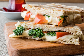 Turkish Bazlama Tost / Toast sandwich with melted cheese, tomatoes, dill and tea.