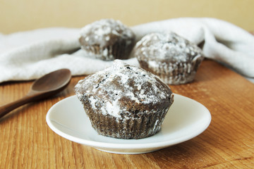 Homemade Chocolate Cupcake on plate against a background