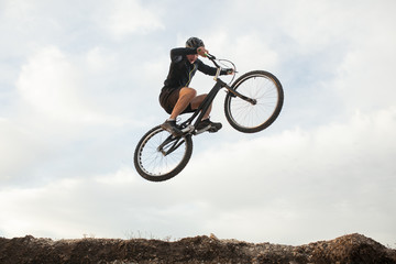 Fototapeta na wymiar man jumping on a bike