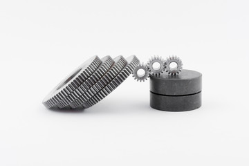 Isolated metal pinions gear. The iron gear on a white background. Pinions in the gearbox. Parts to...