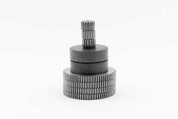 Isolated metal pinions gear. The iron gear on a white background. Pinions in the gearbox. Parts to...