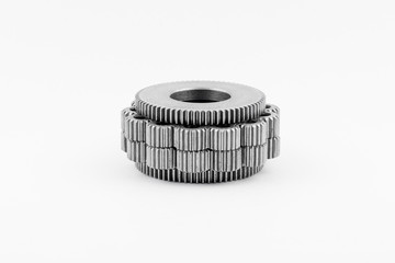 Isolated metal pinions gear. The iron gear on a white background. Pinions in the gearbox. Parts to...