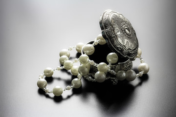 Jewellery box with white pearls with studio lights
