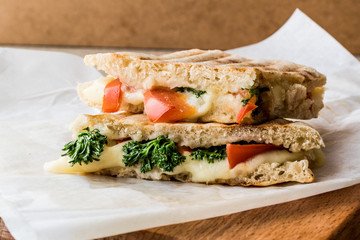 Turkish Bazlama Tost / Toast sandwich with melted cheese, tomatoes and dill.