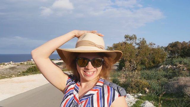 A woman in a hat and sunglasses on vacation