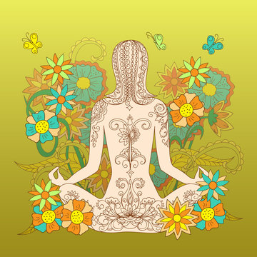 tattoo girl in lotus pose with floral backdrop