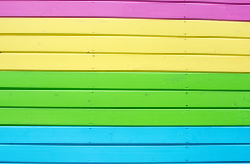 Bright colorful wall of multicolored boards. Pink, green, yellow background. Unusual color...