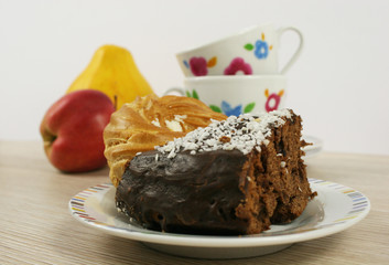 homemade chocolate cake and cup on a wooden table