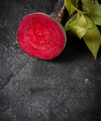 Beets cut on a black stone background. Lots of space for text.
