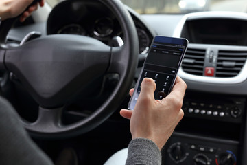 Risky danger driving concept. Man using mobile phone while driving a car