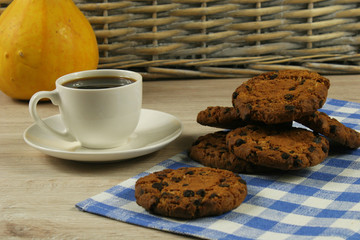 Coffee cup with oatmeal cookie chocolate on wooden background